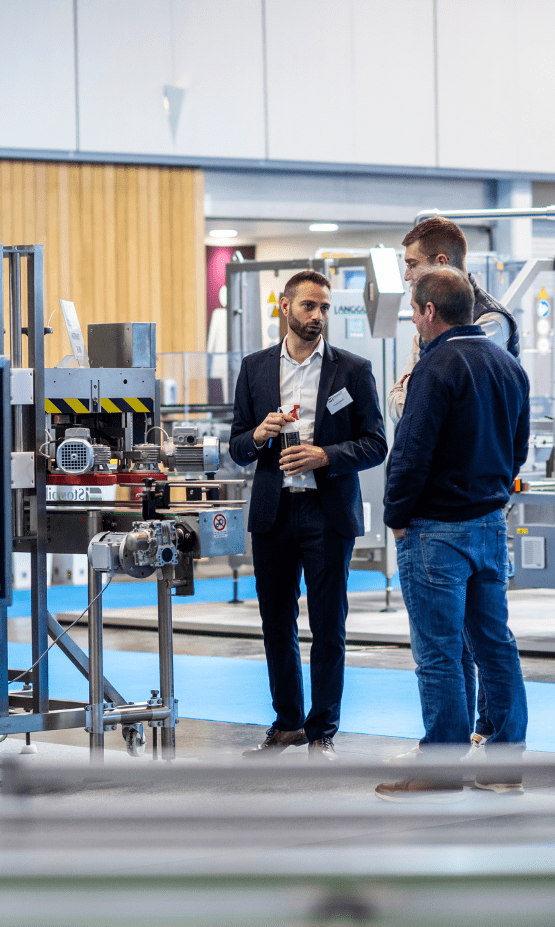 People talking in front of a machine